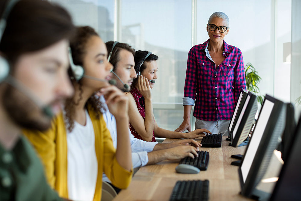 A group of customer service agents working in an office.