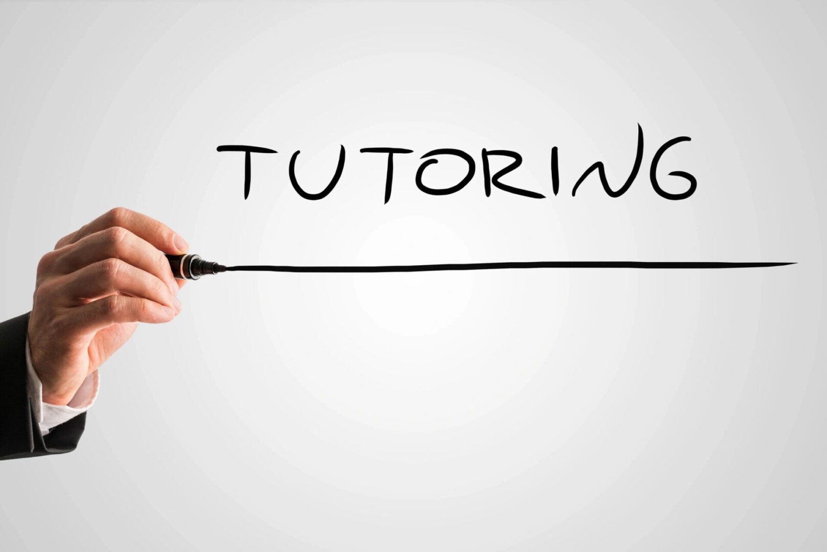 a hand underlining the word tutoring