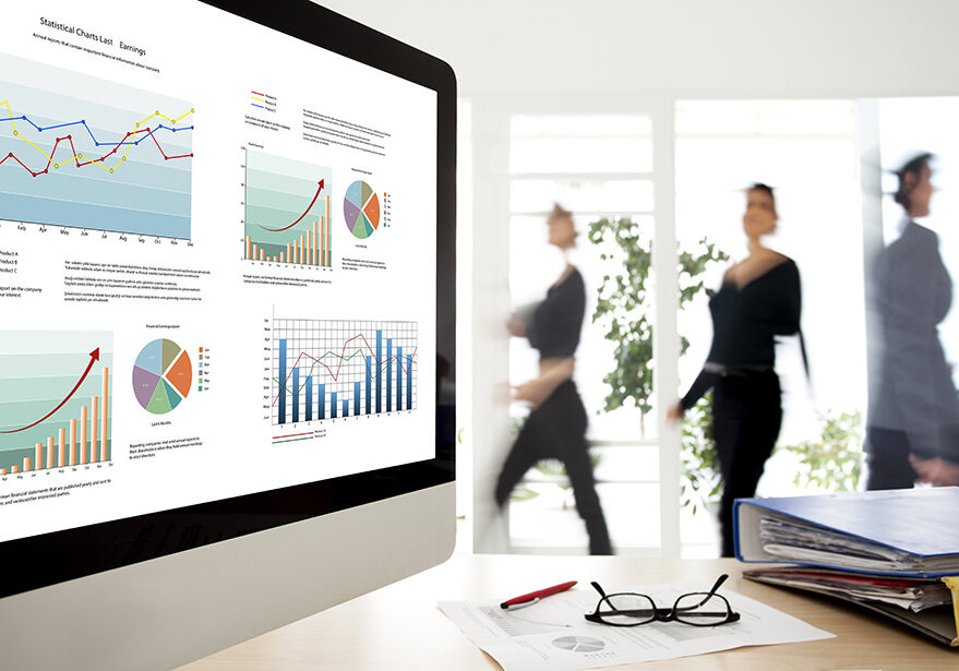 A computer monitor displaying financial charts and graphs.